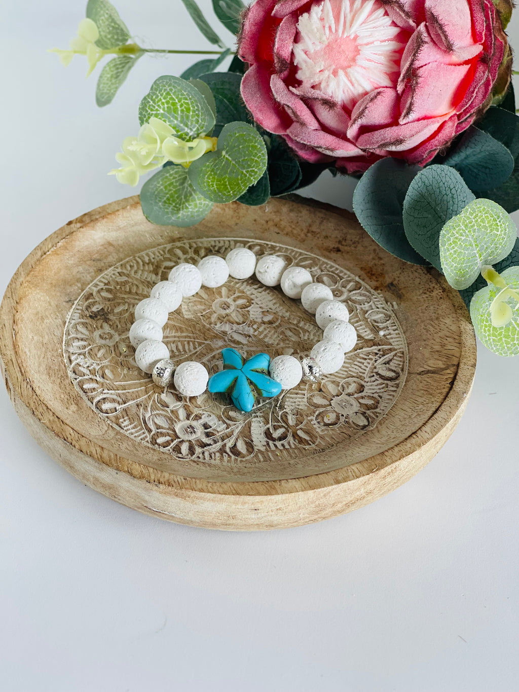 White lava bead with turquoise flower bead